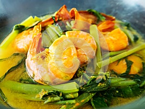 Yellow curry shrimp prawn with morning glory. Traditional local southern food. Delicious sour and spicy soup