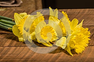 Yellow dafodills on wooden table