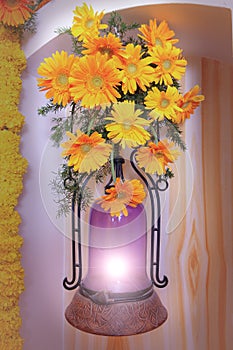 Yellow dahlia flower bouquet on purple wall lamp