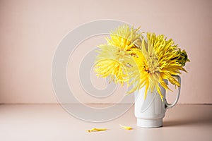 Yellow dahlia flowers in a jug