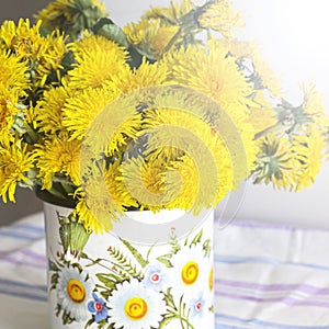 Yellow dandelions in a rustic vase