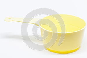 A yellow deciliter measure on white background