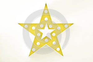 Yellow decorative star with lots of lights on white background