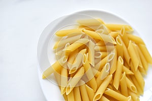 Yellow delicious pasta close-up on a white plate