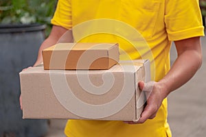Yellow delivery man carry parcels