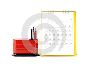 yellow desk calendar with date grid in july 2016 and red desk organizer isolated on white background