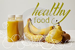 yellow detox smoothies in bottles with bananas, pears and kiwis on white background, healthy food inscription