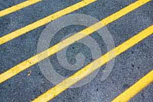 Yellow diagonal lines marking on asphalt road