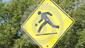 yellow diamond illustration road sign of person running playing with ball