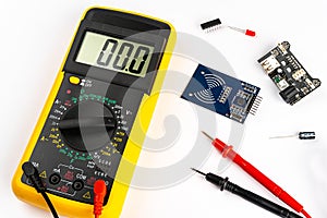 Yellow digital multimeter electronic measurement device tool with red and black cables microc chip circuit board led and micro