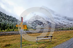 Yellow direction signs along Gemmi Pass Trail. Switzerland\'s Bernese Oberland