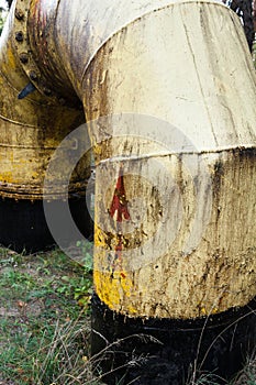 Yellow dirty pipe tube. Red arrow on the pipe