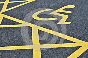 Yellow disability parking space in a row.