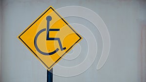 Yellow disable handicap parking sign board placed in a residential area.