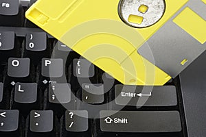 A yellow disket on the enter key pad is concept to warning safe save a datas.