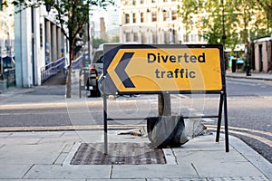 Yellow diverted traffic road sign in a UK city street