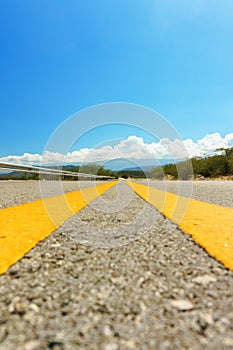 Yellow dividing line on asphalt road