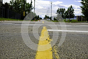 Yellow dividing line on a street in city - Low Angle