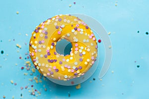 Yellow donut on blue background