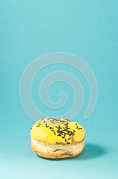 yellow donut isolated on blue background /yellow donut isolated on blue background with copy space