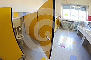 Yellow door into bathrooms with sinks of a nursery