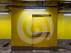 yellow door of exit from underground parking