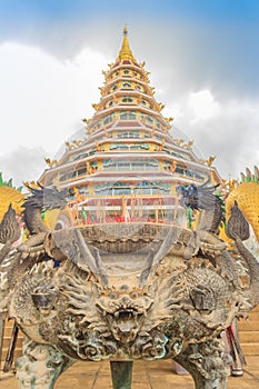 Yellow dragon head at Wat Huay Pla Kang, bublic Chinese temple in Chiang Rai Province, Thailand with dramatic blue sky background