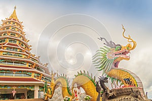 Yellow dragon head at Wat Huay Pla Kang, bublic Chinese temple in Chiang Rai Province, Thailand with dramatic blue sky background