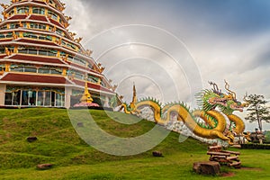 Yellow dragon head at Wat Huay Pla Kang, bublic Chinese temple in Chiang Rai Province, Thailand with dramatic blue sky background