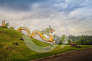 Yellow dragon head at Wat Huay Pla Kang, bublic Chinese temple in Chiang Rai Province, Thailand with dramatic blue sky background