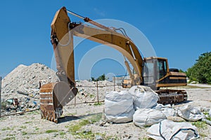 Yellow dredge digging stones at the tropical island Villingili