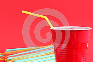 Yellow drinking straw in red cup