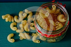 Yellow dry pasta in a glass jar