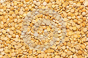 Yellow dry peas background texture, split dried peas closeup