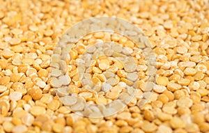 Yellow dry peas background texture, split dried peas closeup