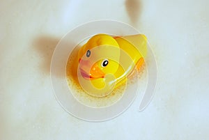 Yellow duck covered from the soap bubbles 03