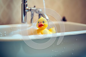 Yellow duck toy in the bathtub. Bath time concept. Generative AI