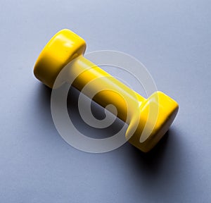 Yellow dumbbell Isolated on blue background