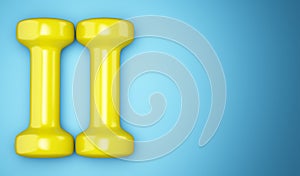 Yellow dumbbells isolated on blue