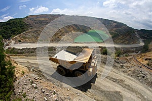 Yellow dump truck on coper surface mining