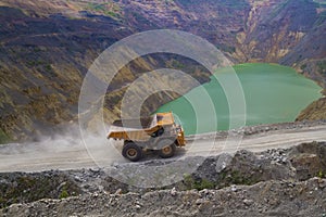 Yellow dump truck on coper surface mining