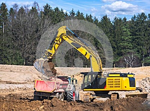 Yellow earth mover at a construction site