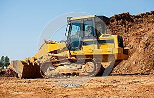 Yellow Earth Mover by Pile of Dirt