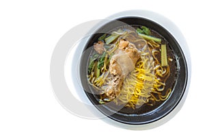 Yellow egg noodles stewed chicken wing in a black bowl isolated Clipping path on white background