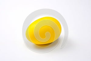 A yellow, egg-shaped, plastic shaker, a musical instrument used in different styles of music