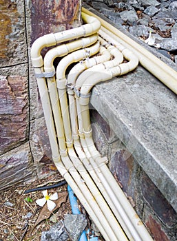 Yellow electrical conduit row with the metal clamp