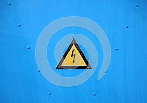Yellow Electrical Warning Triangle Sign on Blue Background