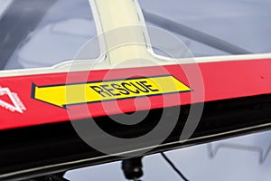 Yellow emergency rescue arrow sign on red military airplane