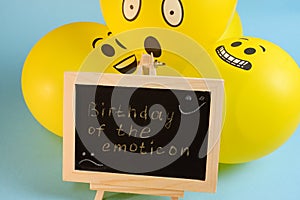 Yellow emoji balloons and a board with the inscription events on a blue background.