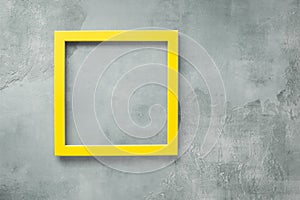 Yellow empty  frame on  rustic gray  surface